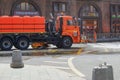 Municipal watering machine washes and spray water on asphalt of Moscow city center streets .Urban public utilities Royalty Free Stock Photo