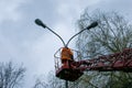 A municipal worker in protective gear replacing bulbs in a street lamp. Royalty Free Stock Photo