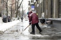 Municipal worker removing snow and ice from streets of city after blizzard