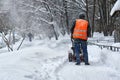 Municipal worker removing snow from the moscow street using snow blower Royalty Free Stock Photo