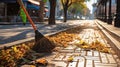 Municipal worker sweeping road at fall day