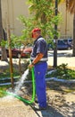 Municipal worker watering a garden city Royalty Free Stock Photo