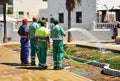 Municipal workers watering a garden city Royalty Free Stock Photo