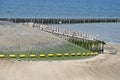 Wooden piles, basalt, beach, sea