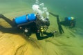 Munising, MI -August 14th, 2021: SCUBA diver checking gauges underwater