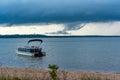 Munising Michigan, USA - August 11, 2021: Pontoon boat anchored near a beach