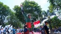 General Participants At A Carnival Party Accompanied By A Green Mascot Statue