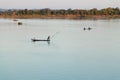 Muong Khong Laos 1/12/2012 Mekong river at sunset with and fishing boat and nets Royalty Free Stock Photo