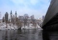 Mur river with Murinsel bridge and Mariahilfer church in the background, in Graz, Styria region, Austria, with snow, in winter