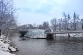 Mur river with Murinsel bridge and Mariahilfer church in the background, in Graz, Styria region, Austria, with snow, in winter