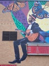 mural art of guitar player and butterflies (on building wall)