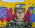 A mural by artist Juan Velazquez featuring Vanessa Guillen in Army fatigues on a business in Fort Worth, Texas.