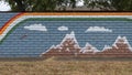 Mural on a barrier wall between Forest Lane and the neighborhood on the North side, painted in 1976 by art students.