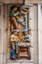 Mural ceramic reliefs depicting laborers and traditional local workers in Girona, Spain