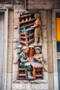 Mural ceramic reliefs depicting laborers and traditional local workers in Girona, Spain