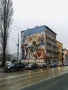 A mural commemorating the artist Sylwester Checinski over busy road