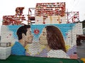 Mural of a couple about to kiss in the colorful Gamcheon culture village in Busan