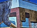 Mural on abandoned blue brick building