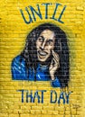 Mural of famous Jamaican singer Bob Marley on the brick wall