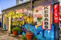 Mural graffiti wall art of the side of a kebab shop and fish and chips