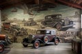 mural of past and present vintage vehicles on the wall of workshop