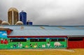 Mural on red barn side with farm animals in Spring