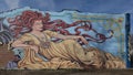 Mural titled `The Tattoo Woman` by artist Derek Vosten on East Main Street in downtown Norman, Oklahoma.