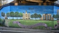 Mural on underpass featuring historic buildings and a message to `Keep Denton Beautiful` by muralist Dan Colcer.