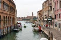 Murano canal with old building and people. Italy