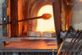 Murano glass-blowing factory. Glass blower forming beautiful pie