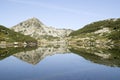Muratov peak and its reflection in Banderishko Frog lake in the Pirin National Park, Bulgaria Royalty Free Stock Photo
