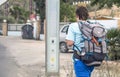 Murcia, Spain, April 17, 2019: Young man wearing huge backpack walking along the street. Travelling by interrail