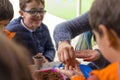 Murcia, Spain, February 5, 2020: Young children learning how to plant seeds in garden. Hands holding seeds and black soil in pot. Royalty Free Stock Photo