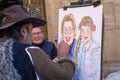 Murcia, Spain - January 30, 2023: A street artist draws a portrait of a grandmother and her granddaughter in the streets of