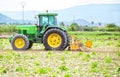 Murcia, Spain, May 7, 2020: Farmworker riding tractor tilling or plowing the earth. Preparation to cultivate in agricultural field Royalty Free Stock Photo