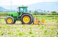 Murcia, Spain, May 7, 2020: Farmworker riding tractor tilling or plowing the earth. Preparation to cultivate in agricultural field