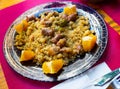 Murcian Migas from fried flour crumbs with peppers, sausages, bacon, orange Royalty Free Stock Photo