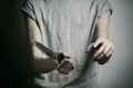 Murder and Halloween theme: a man holding a knife on a gray background Royalty Free Stock Photo