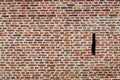 A murder hole was ordered in a brick-built wall in Lille (France)