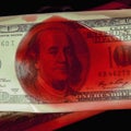 Murder for money. Close up US Dollar bills in blood as symbol of terrorism, death, suffering, loss and violence