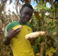 Young farmer holding corn cob in hands