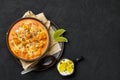 Murgh Makhani or Butter Chicken in black bowl on dark slate table top. Indian Cuisine dish with meat and creamy masala Royalty Free Stock Photo