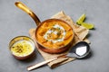 Murgh Makhani or Butter Chicken in copper bowl on gray concrete table top. Indian Cuisine dish Royalty Free Stock Photo