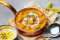 Murgh Makhani or Butter Chicken in copper bowl on gray concrete table top. Indian Cuisine dish Royalty Free Stock Photo