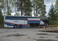 Murjek, Norrbotten, Sweden, Agust 22, 2019: Young hiker tourist get off Bussgods Bus at Train station in Murjek, Swedish Lapland.