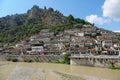 Murky river running past idyllic downtown of an ancient Ottoman city in Albania Royalty Free Stock Photo