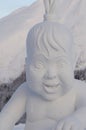 Murmansk, Russia - January 26, 2014. The snow figure is made in the image of a Sami boy sitting with a tambourine, is in