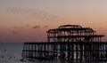 Murmuration of starlings over the ruins of West Pier, Brighton UK. Photographed at dusk, January 2023.