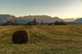 The Murnauer Moos on sunset with a hay bale in the foreground