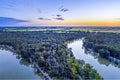 Murray River bends among trees at dusk.